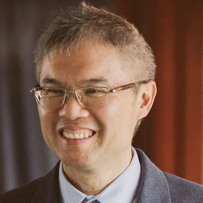 Portrait of Jonathan, a team member at OptimySME, smiling in a business environment.