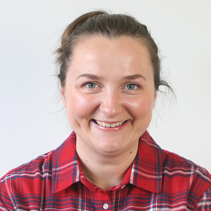 Portrait of Kristina, a team member at OptimySME, smiling in a business environment.