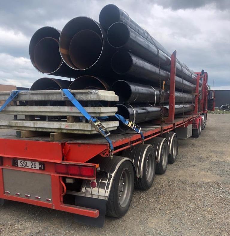 Industrial pipeline system with valves and connections, set in a manufacturing or processing facility.