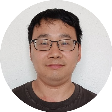 Portrait of Zhikun, a team member at OptimySME, smiling in a business environment.